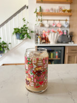 A cute 16oz glass coffee cup that is shaped like a beer can and has valentine designs around the cup in red, pink, yellow, and white. There is a heart shaped box of chocolates, champagne tower, bouquet of flowers, cherries, lockets, heart shaped cake, strawberries, bows, and flowers. The perfect galentine cup. 