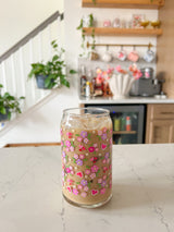 A cute 16oz glass coffee cup that is shaped like a beer can and has purple, pink and hot pink hearts all over the glass with red hearts with doilies around them. The perfect subtle valentine glass or galentine glass. 