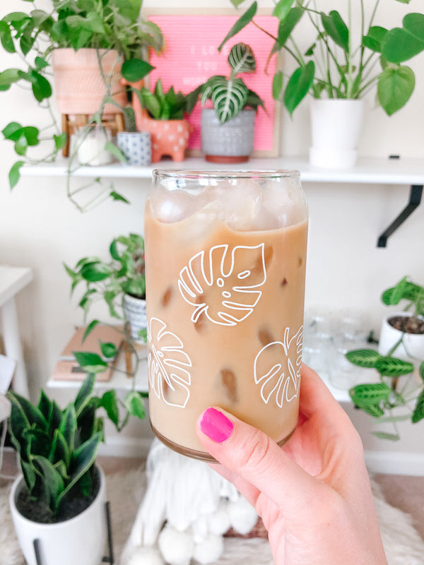 This is a 16oz beer can glass that has white monstera leaves going around the glass for six in total. It is the perfect glass for drinking an iced coffee or matcha latte out of. 