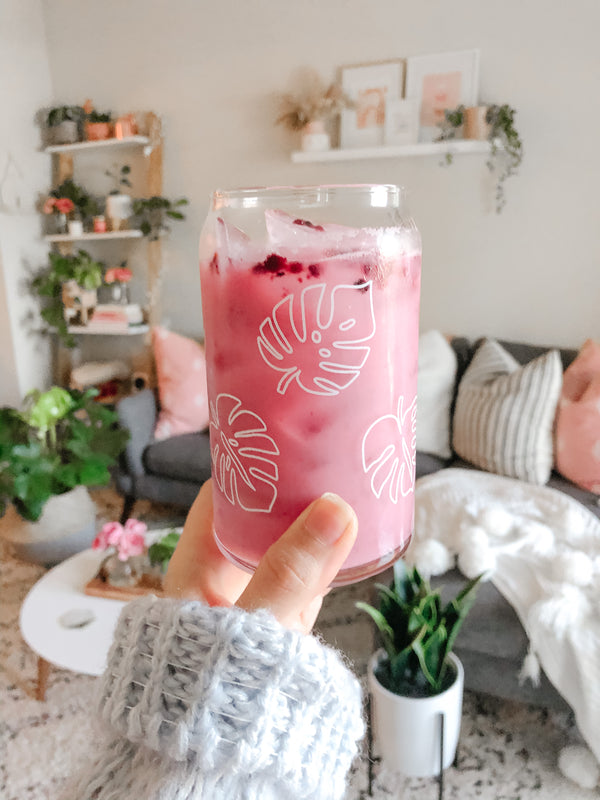 This is a 16oz beer can glass that has white monstera leaves going around the glass for six in total. It is the perfect glass for drinking an iced coffee or matcha latte out of. 